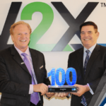 Executive Mosaic’s Jim Garrettson Delivers Booz Allen Hamilton’s Judi Dotson 2023 Wash100 Award