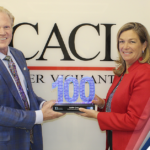 Executive Mosaic’s Jim Garrettson Delivers Booz Allen Hamilton’s Judi Dotson 2023 Wash100 Award